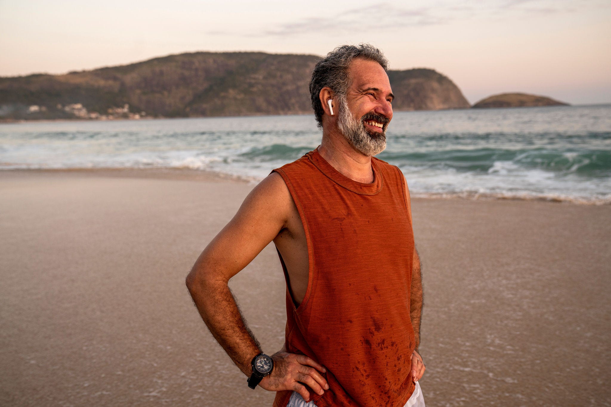 Portrait of relaxed senior man at the beach at sunset