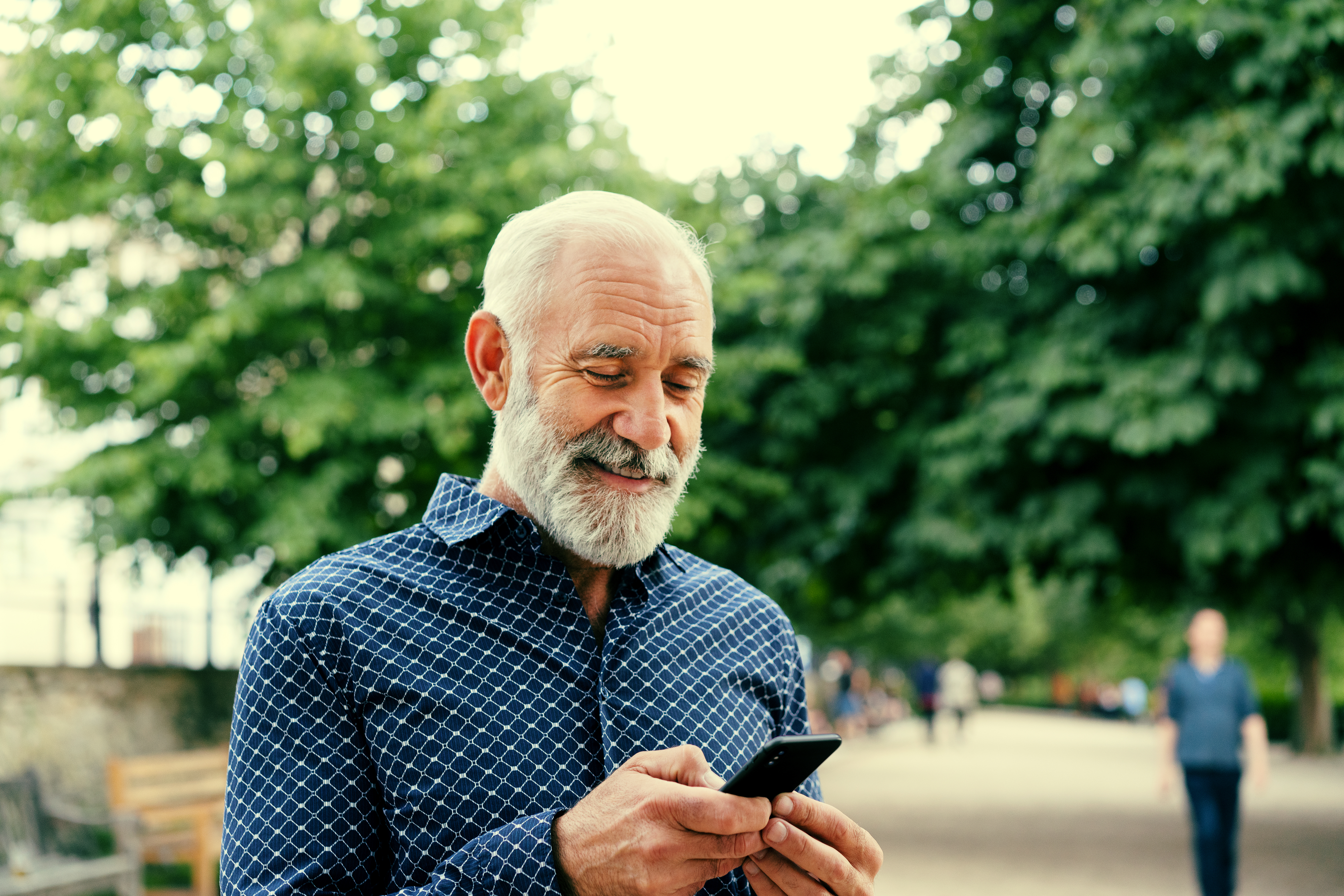Man with beard using phone